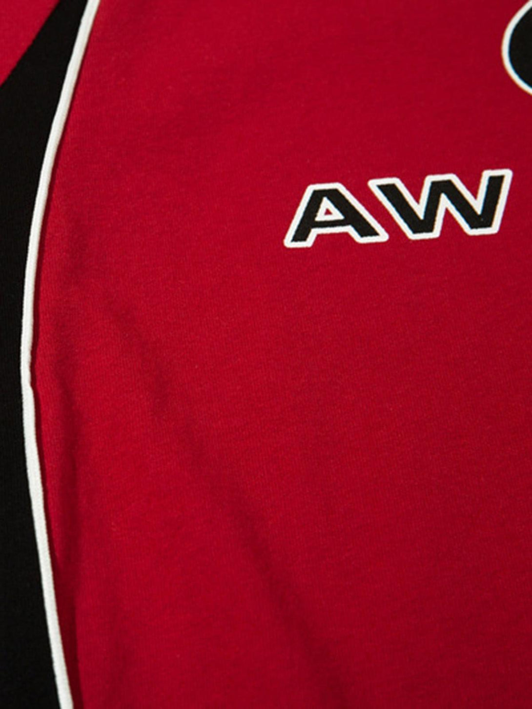 A detailed view of a red racing T-shirt by TALISHKO, highlighting bold color-block details.