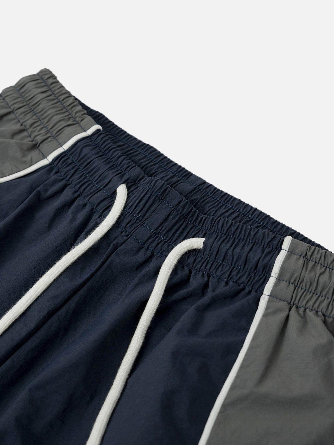 A close-up of TALISHKO color-blocking athleisure shorts, showcasing the elastic waistband and drawstring.