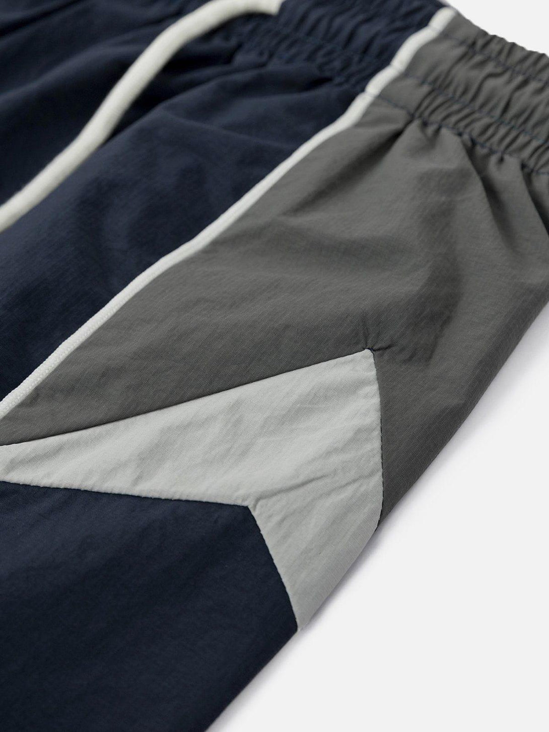 Detailed view of TALISHKO color-blocking athleisure shorts, highlighting fabric texture and design.