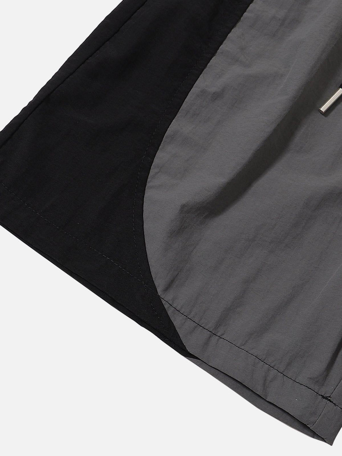 Detailed fabric and stitching in TALISHKO's color-blocking drawstring shorts, showcasing style.