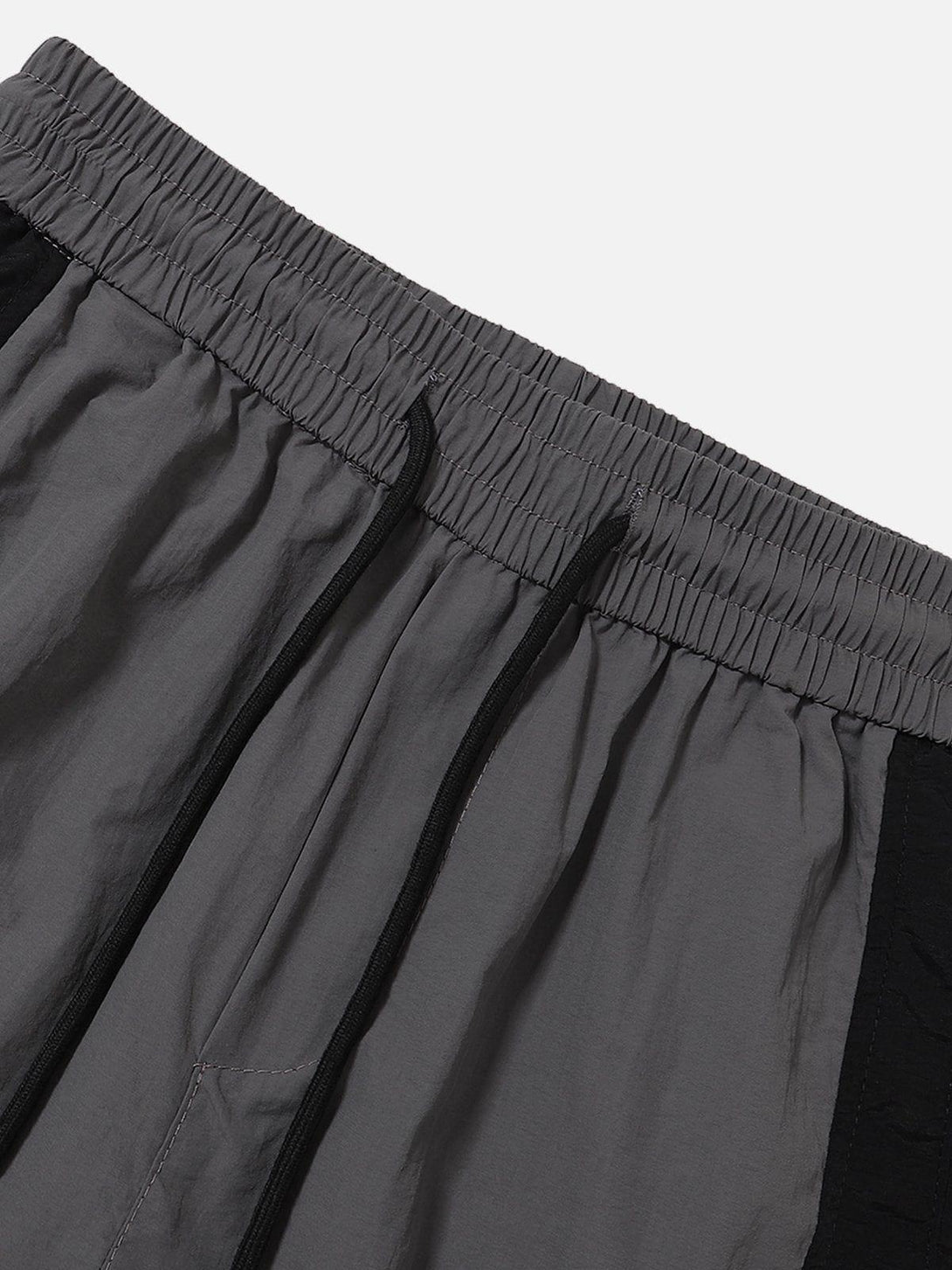 Elastic waistband detail of TALISHKO color-blocking shorts, highlighting drawstring feature.