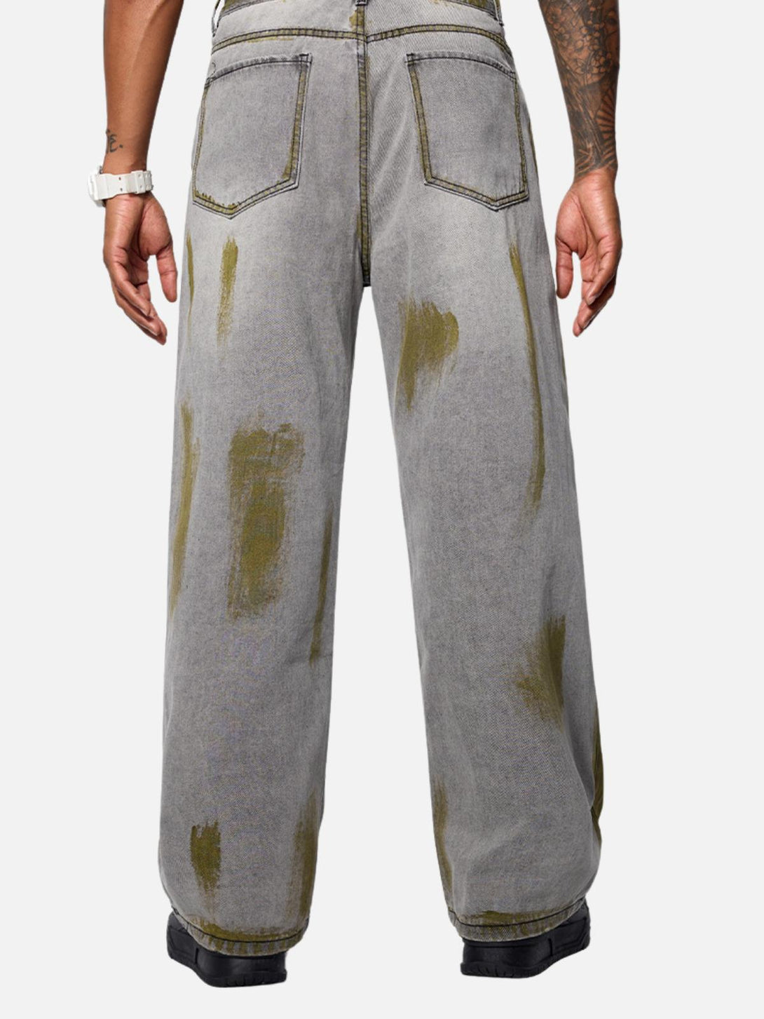 Back view of TALISHKO's loose jeans with unique color blocking, highlighting relaxed style.