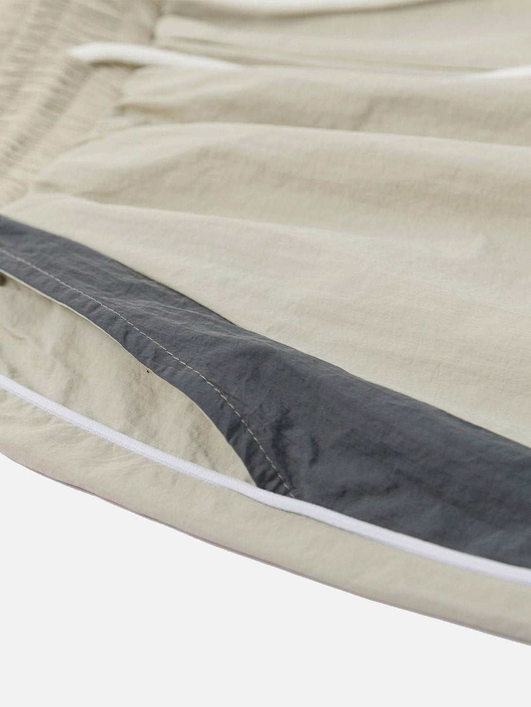 Detailed fabric and stitching on TALISHKO color blocking shorts, showcasing texture and design.