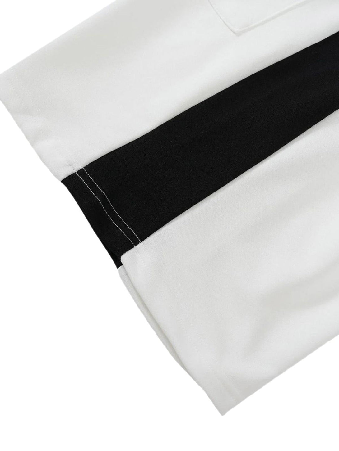 Detailed view of black and white TALISHKO casual shorts, highlighting the side stripe design.