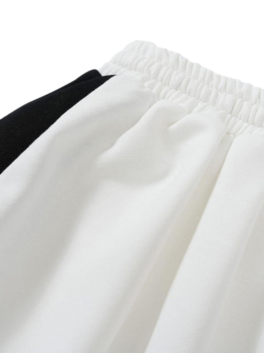Detailed fabric and stitching of black and white TALISHKO casual shorts, showcasing elastic waistband.