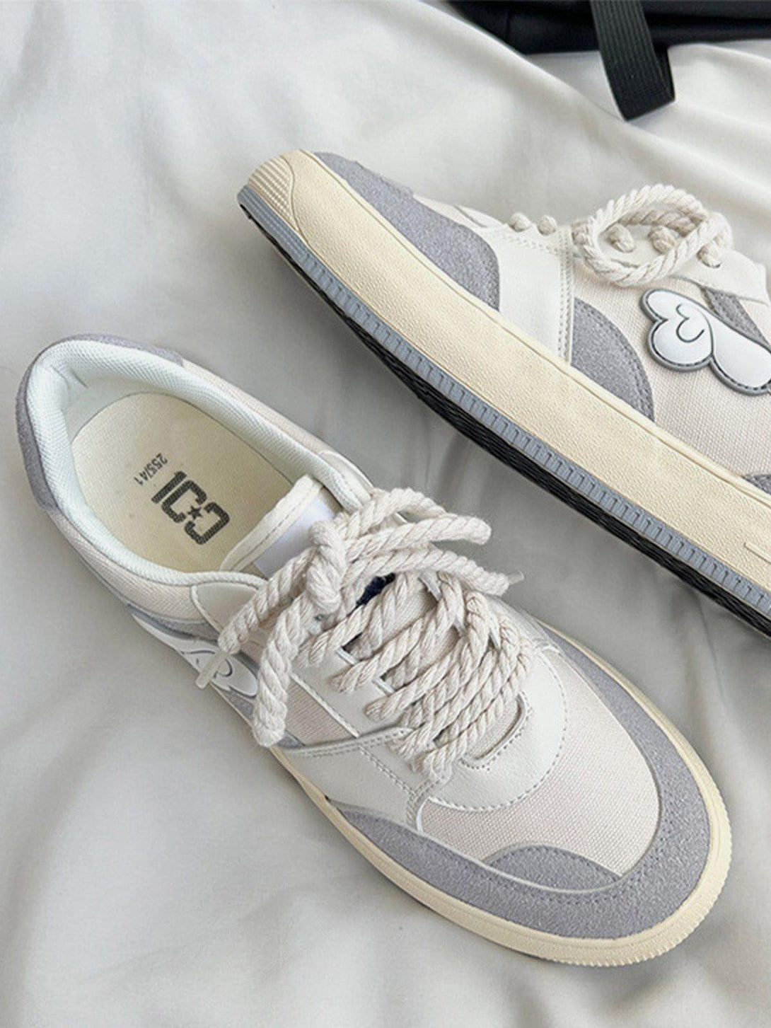 TALISHKO canvas shoes with a colorblock design and wings graphic, showcasing stylish details.