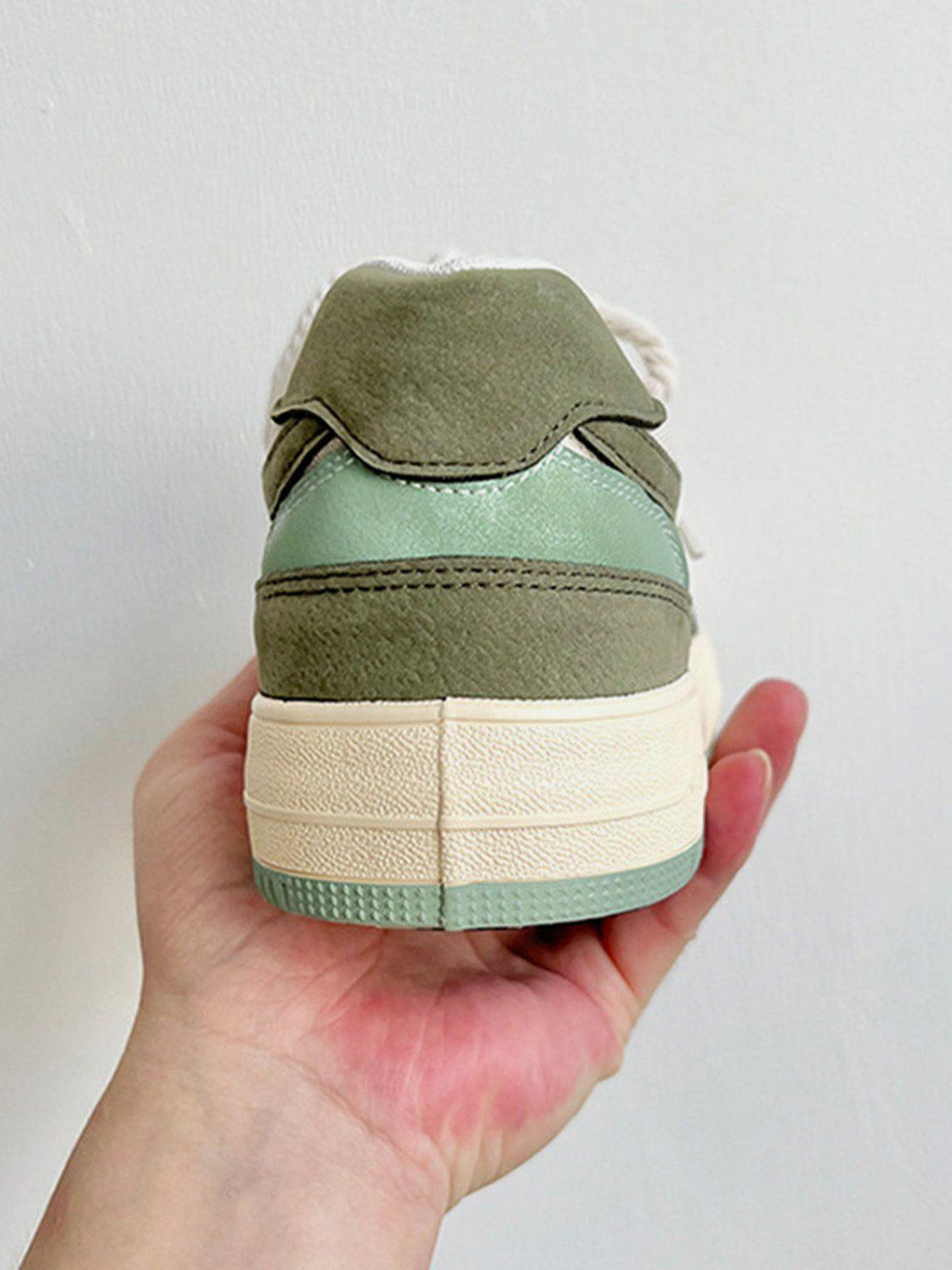 TALISHKO canvas shoes featuring a green colorblock design, captured from the back view.