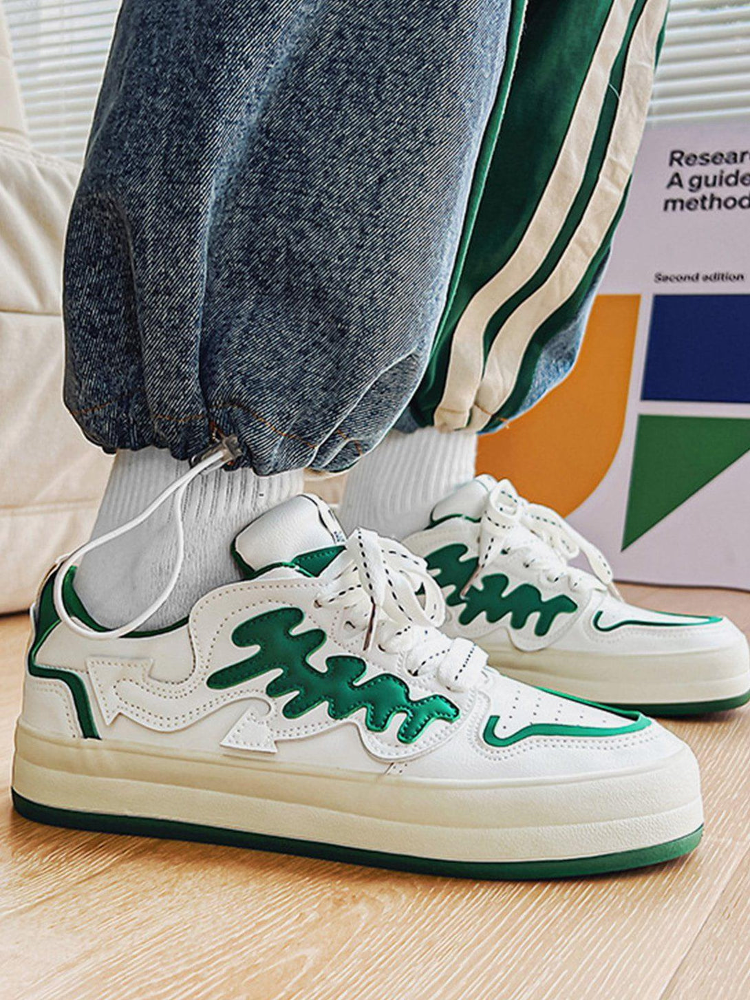 Side view of TALISHKO white and green platform shoes with wavy patch detail, adding a stylish touch.