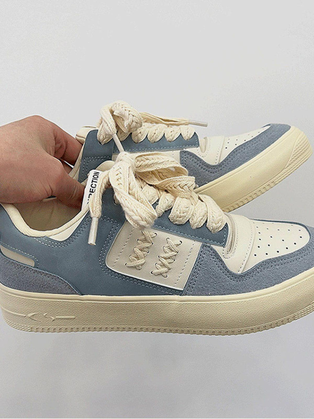 TALISHKO skate shoes with cream and blue colorblock design, featuring unique rope laces.