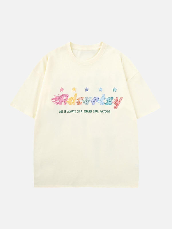 Cream T-shirt featuring colorful star print and lettering by TALISHKO, perfect for vibrant style.