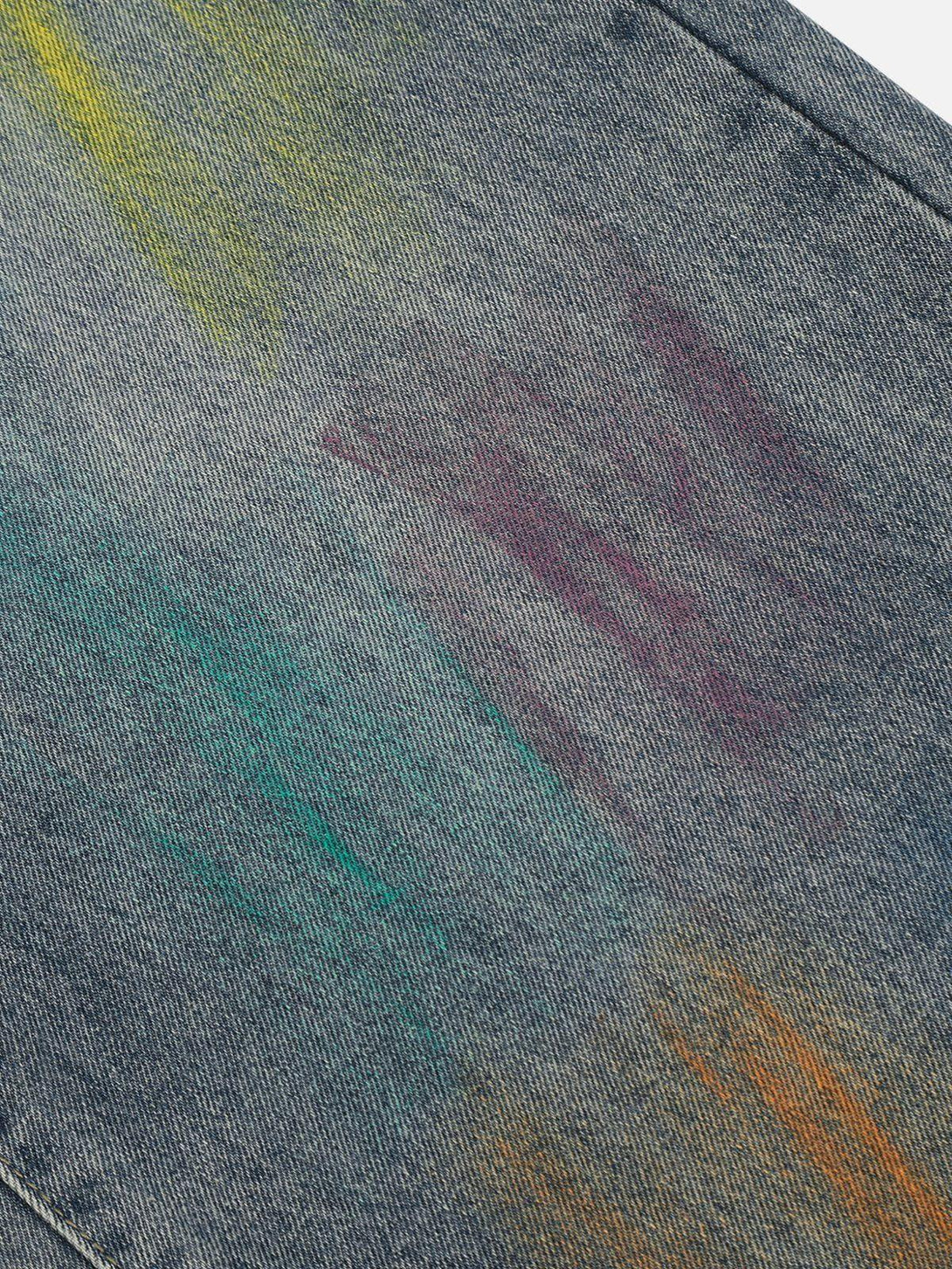 A close-up of TALISHKO graffiti jeans, highlighting the vibrant, colorful texture and design.
