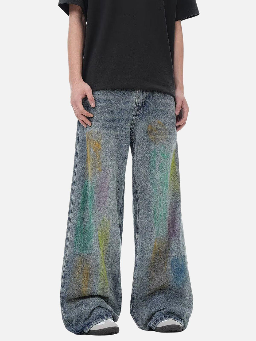 Street-style graffiti jeans by TALISHKO with vibrant colors, worn by a model for a bold look.