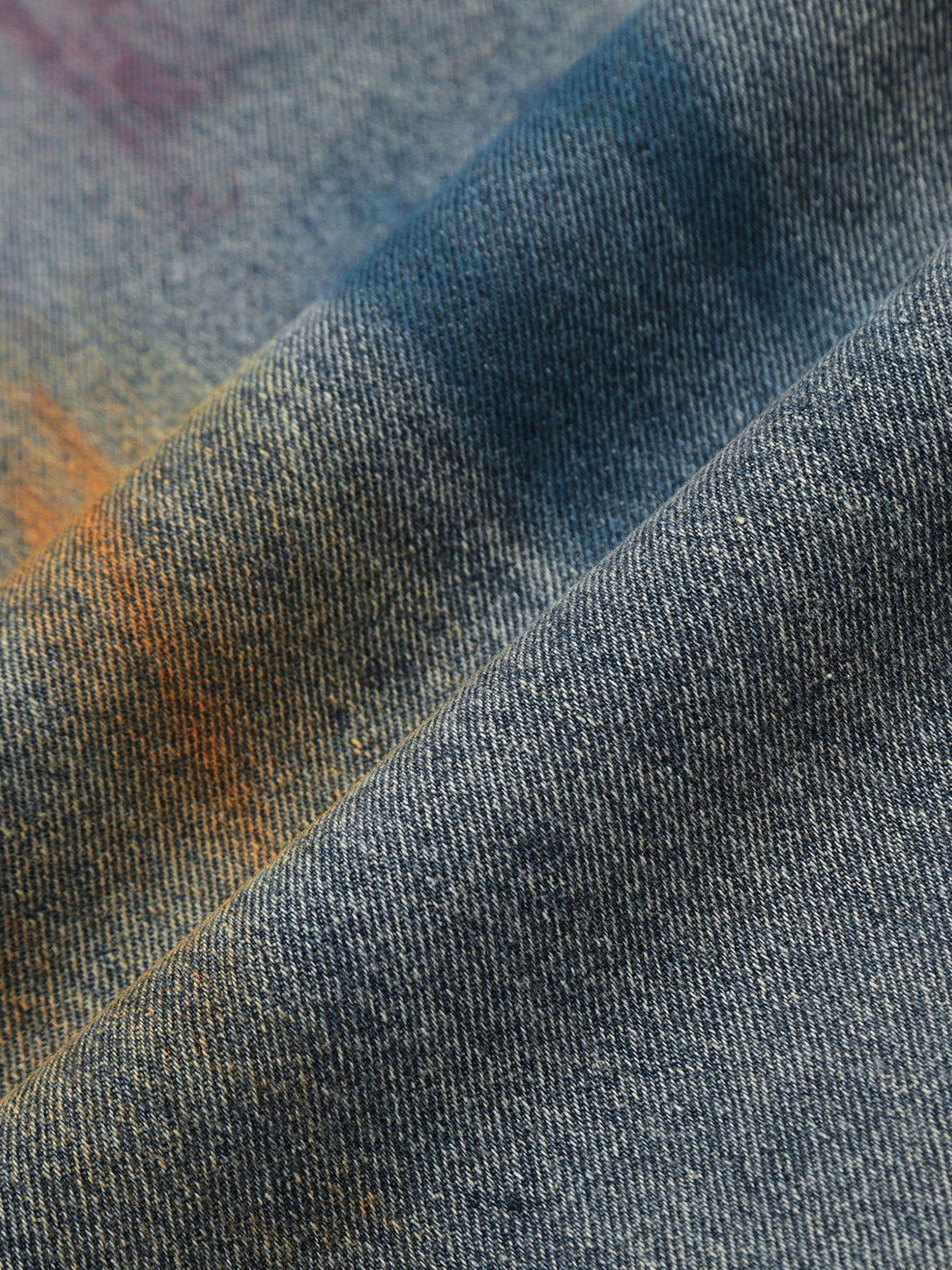 Intricate look at TALISHKO graffiti jeans, showcasing unique colorful patterns and textures.