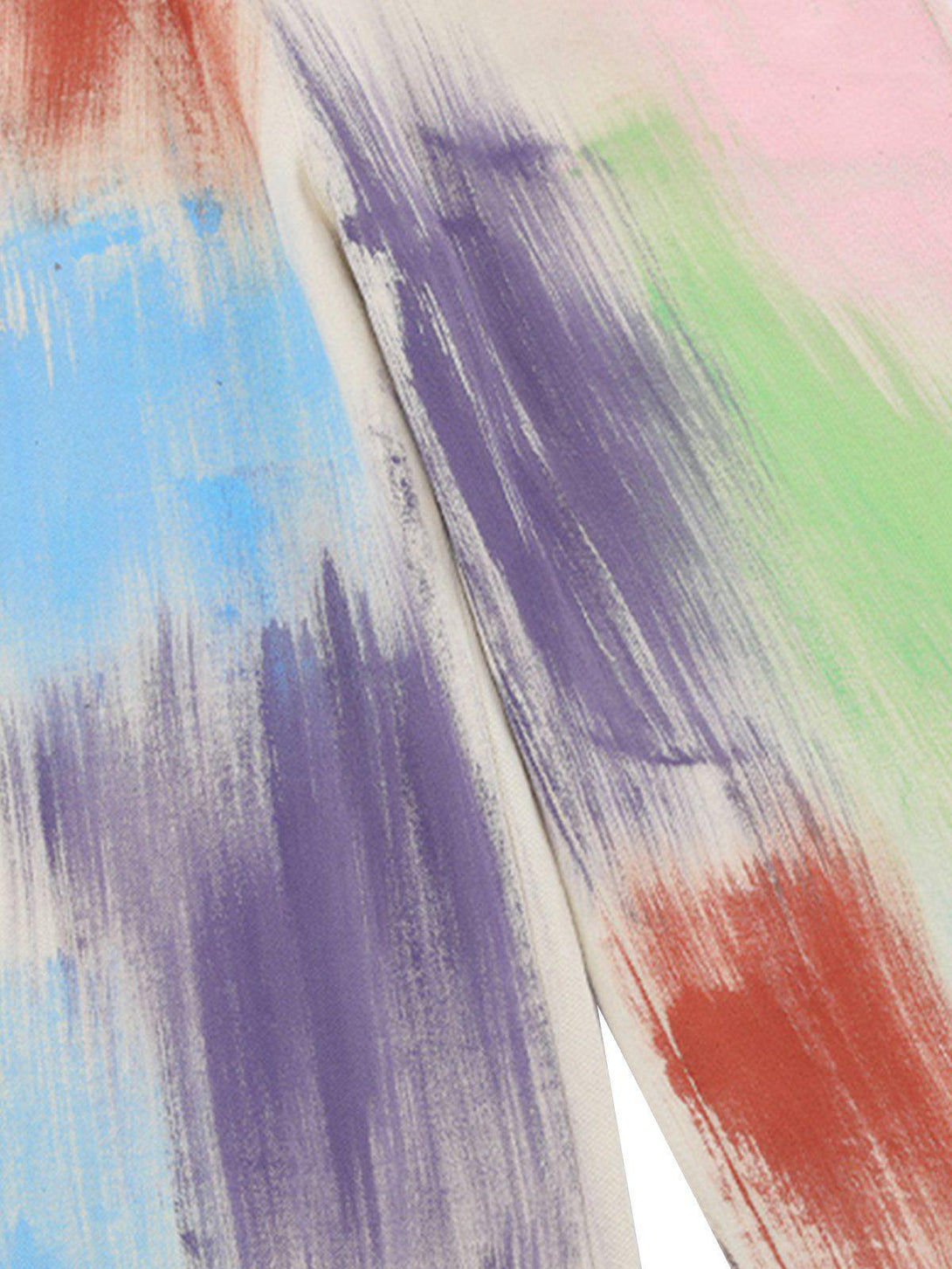 A tight crop highlighting TALISHKO overalls with vibrant, artistic brushstroke patterns.