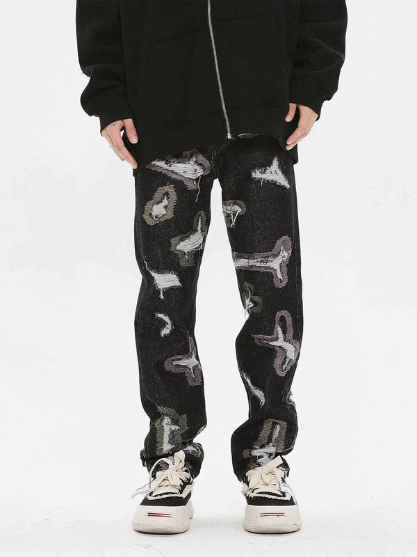 Model wearing TALISHKO colorful hole jeans with abstract patterns and casual sneakers.