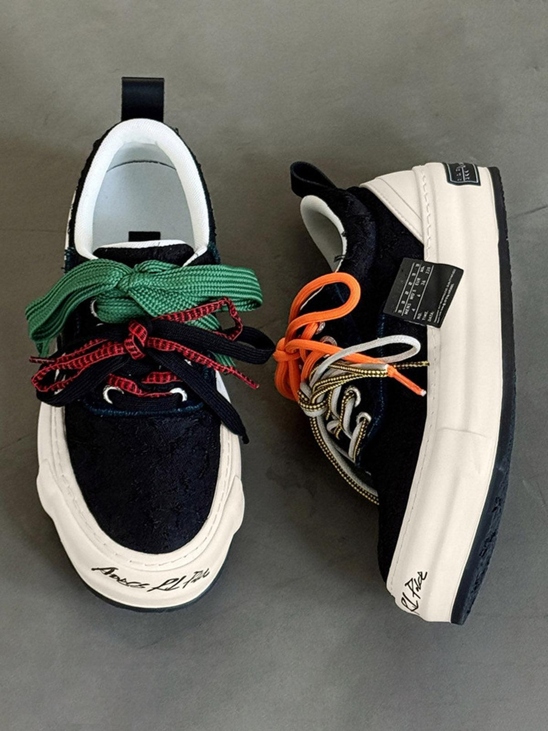 TALISHKO sneakers with mismatched colorful laces, showcasing a bold and eclectic design.