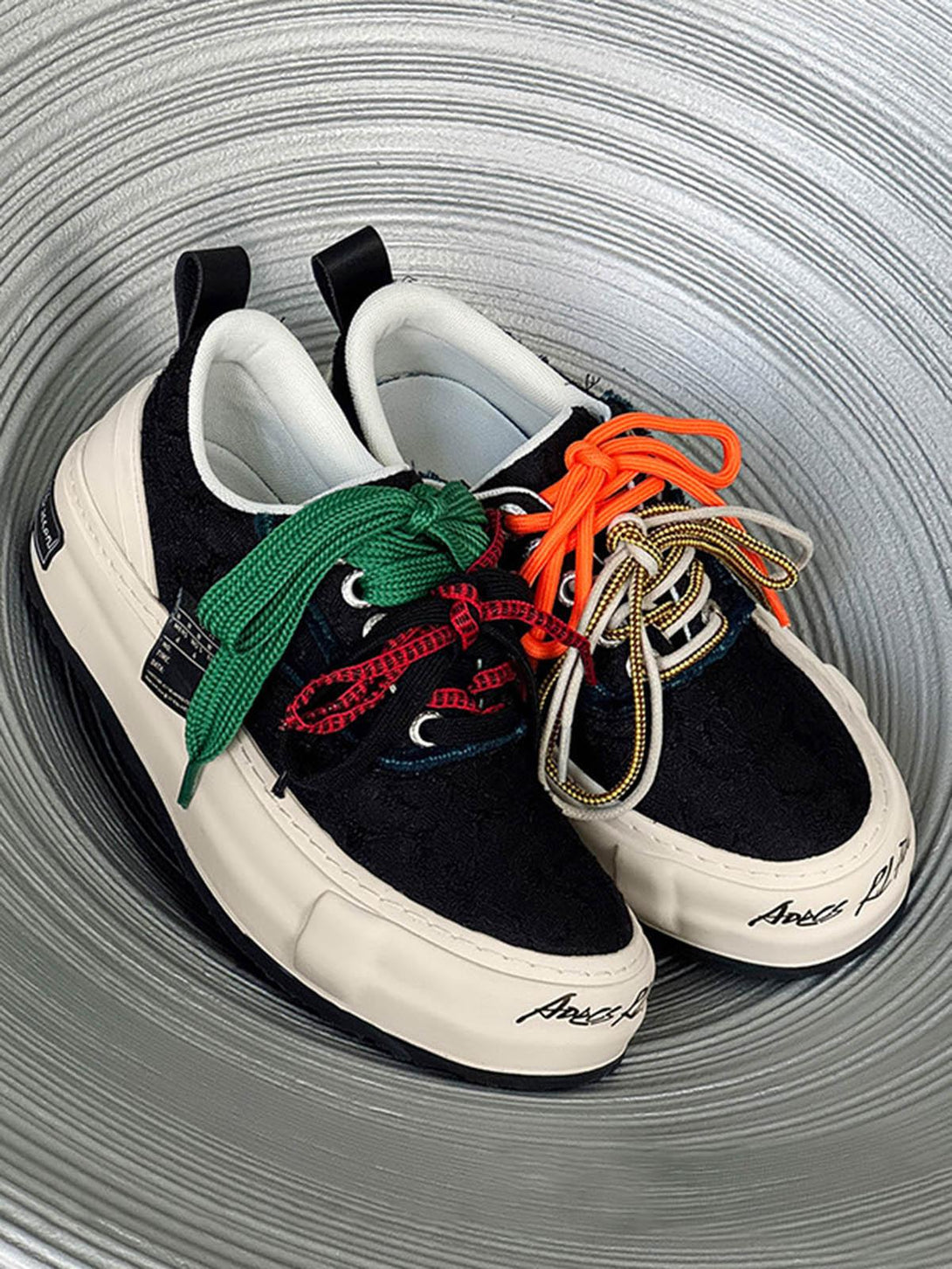 TALISHKO sneakers with a mix of colorful laces, showcasing a bold and unique design.
