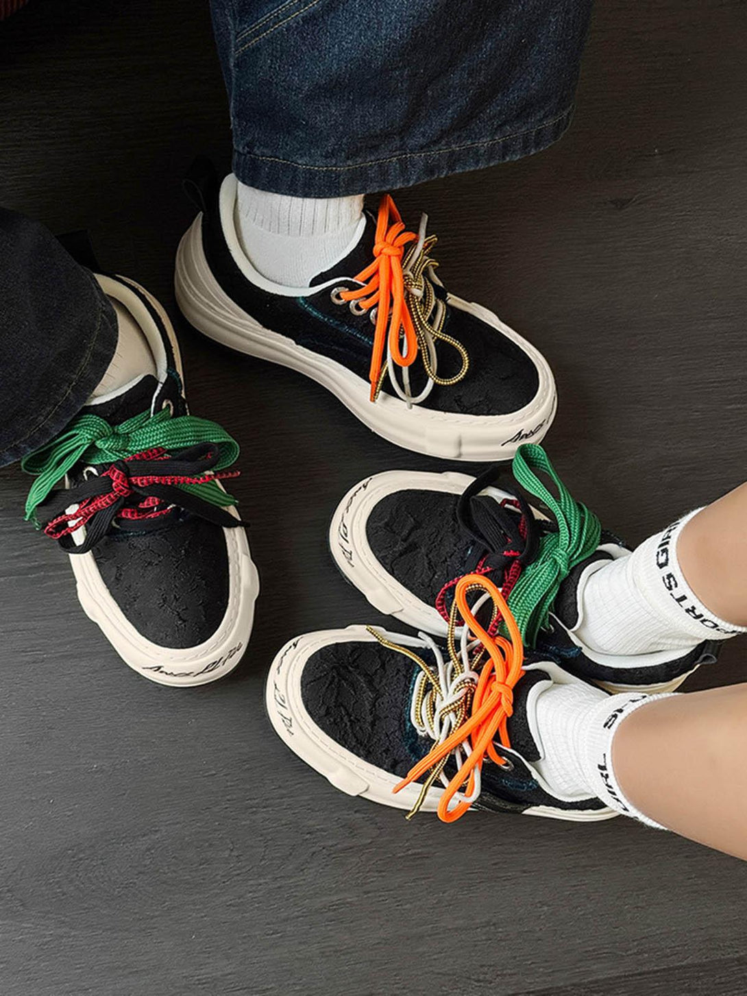 TALISHKO sneakers with playful, mismatched laces styled with casual denim for a trendy vibe.