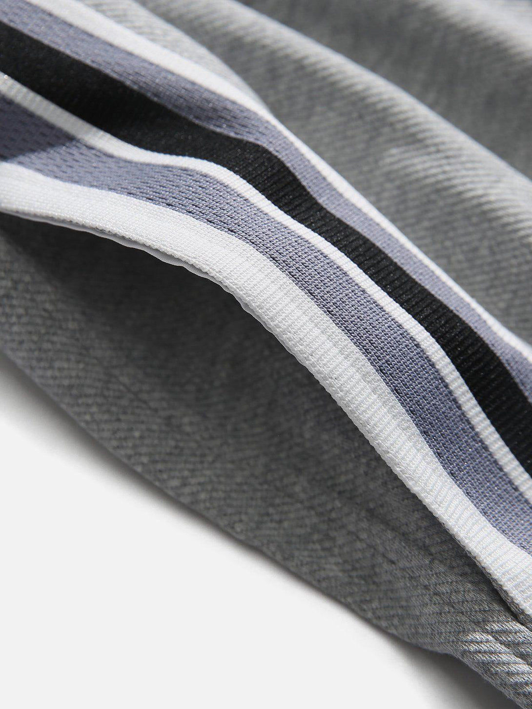 Zoomed-in texture of TALISHKO shorts, showcasing colorful stripes and soft fabric detail.