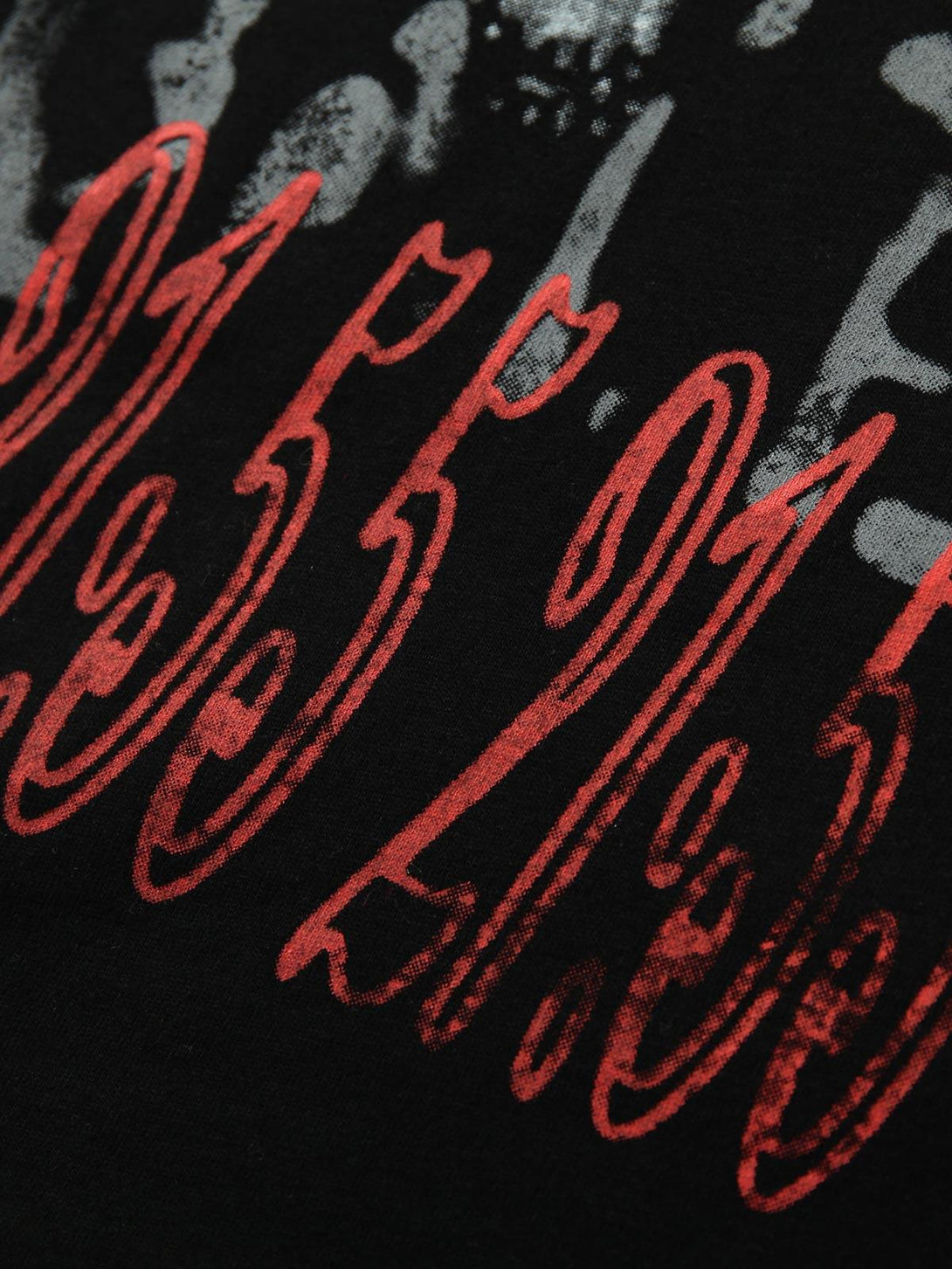 Intricate look at TALISHKO's bold red graphic print on a contrast color patchwork T-shirt.