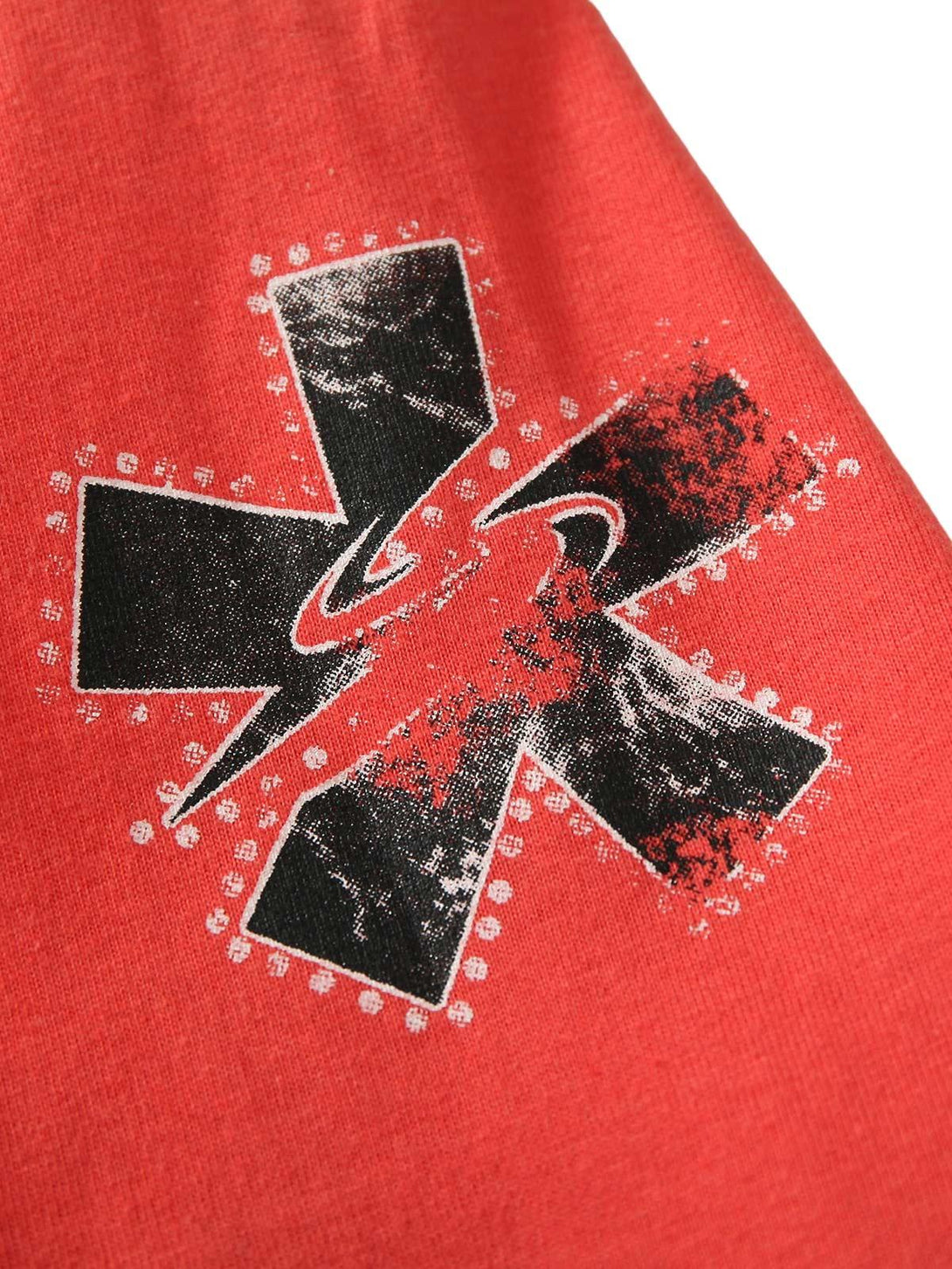 A detailed view of TALISHKO's bold graphic design on a contrast color patchwork T-shirt.