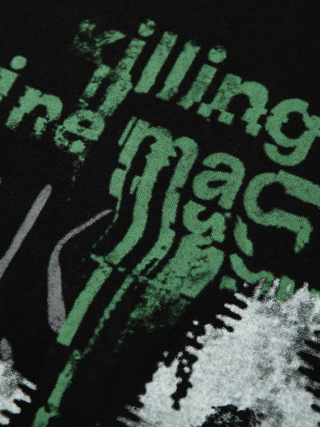 A tight crop highlighting TALISHKO's bold print and graphic detail on a patchwork T-shirt.