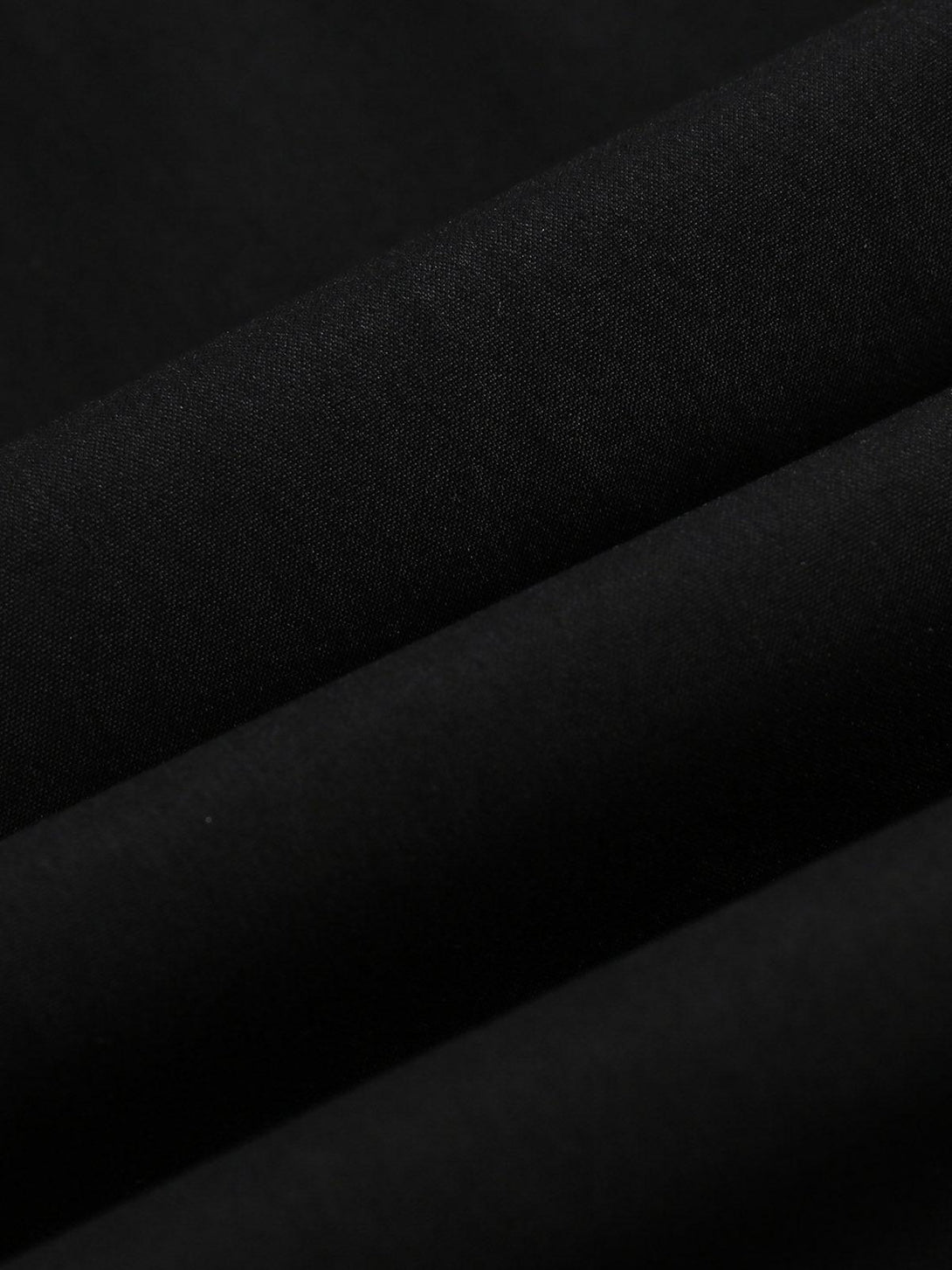 Zoomed-in texture of black fabric from a TALISHKO track jacket, highlighting material quality.