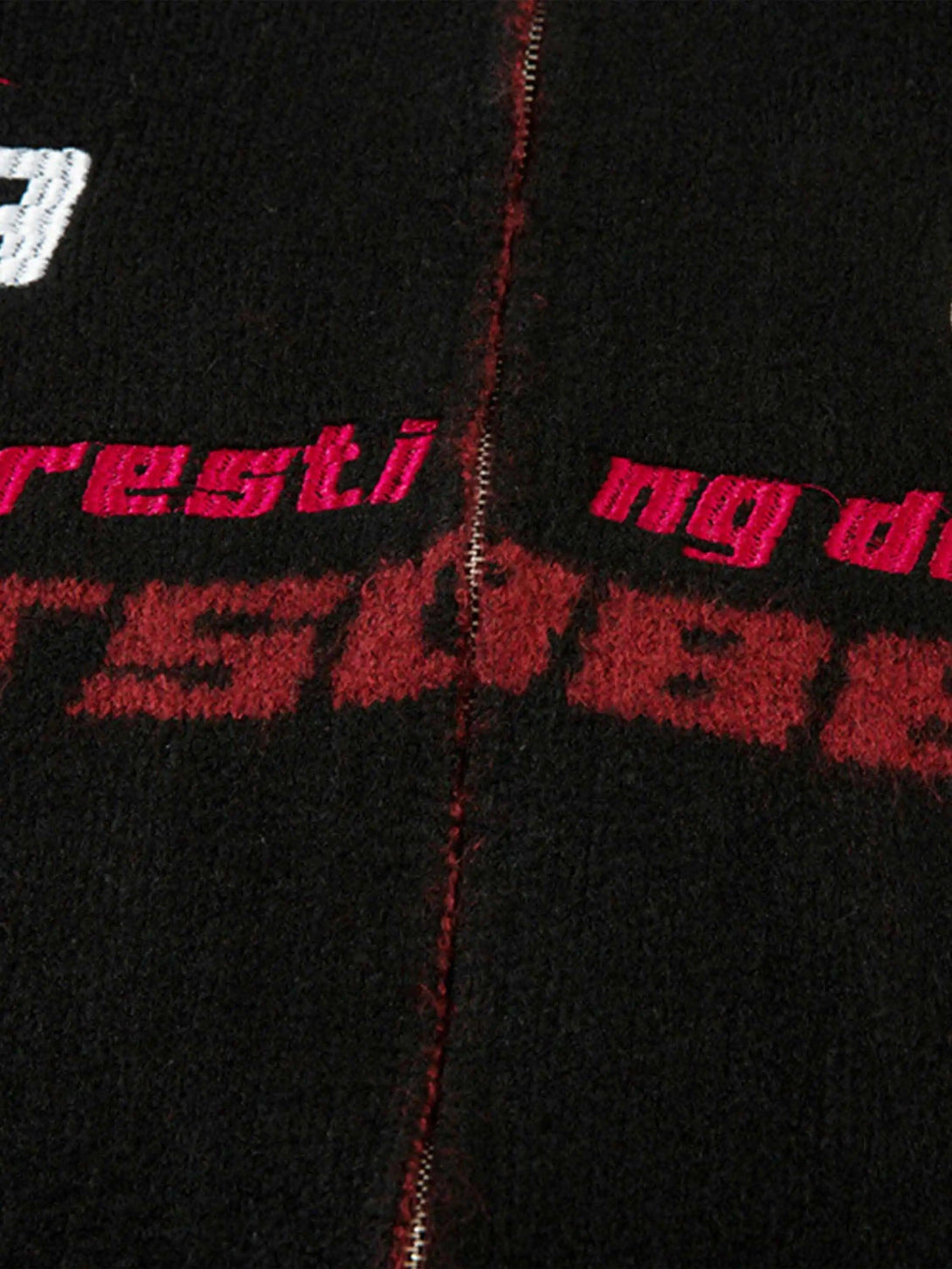 Intricate look at TALISHKO's zip-up cardigan, showcasing bold red racing graphics and texture.