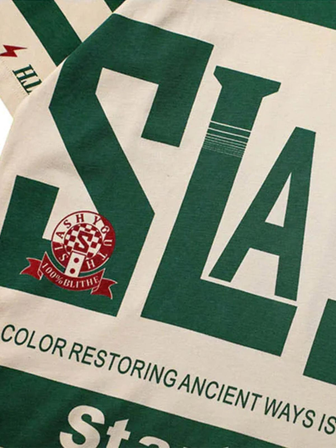 Detailed fabric and graphic design of TALISHKO's contrast color polo shirt, focusing on bold text.