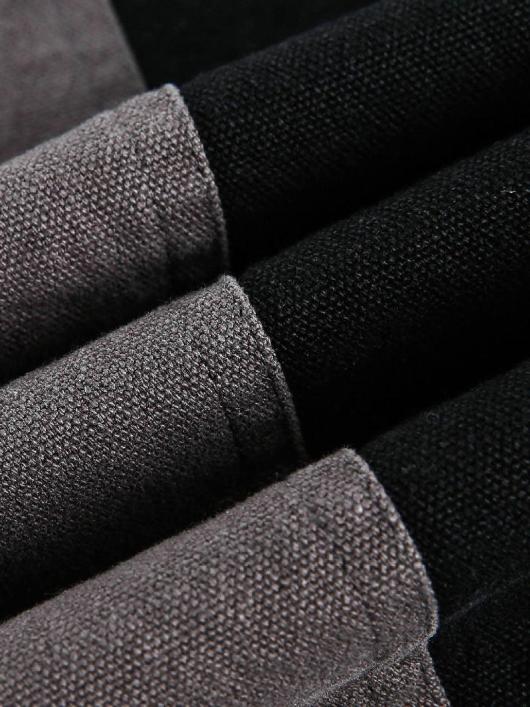 Zoomed-in texture of the TALISHKO jacket, highlighting its contrast spliced fabric detail.