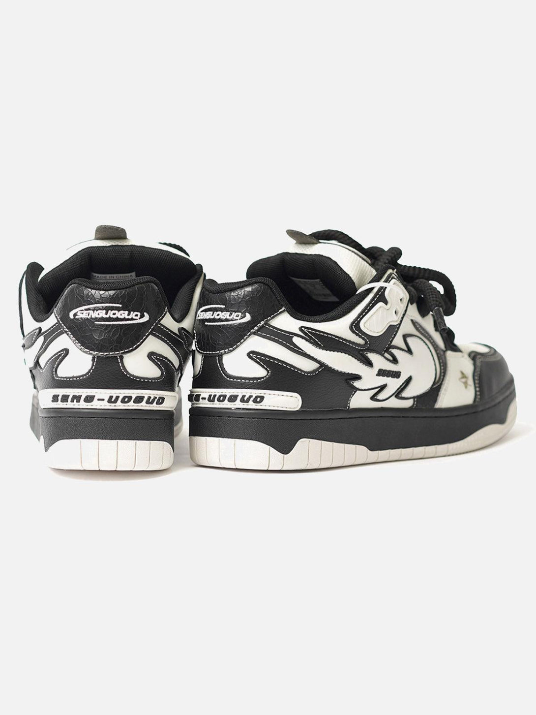 Black and white sneakers by TALISHKO with star accents, rear view showcasing bold style.