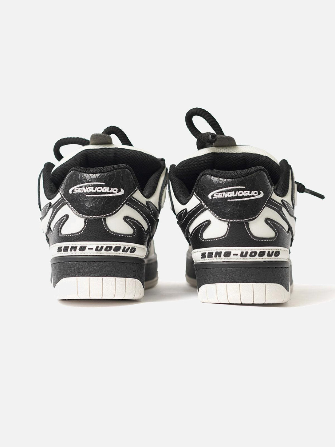Rear view of TALISHKO sneakers in black and white, emphasizing unique contrast design.