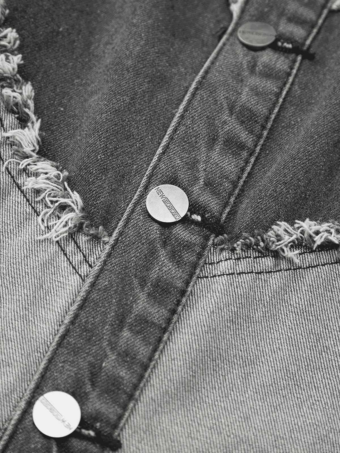 A detailed look at TALISHKO's denim vest, showcasing frayed edges and heart stitching.