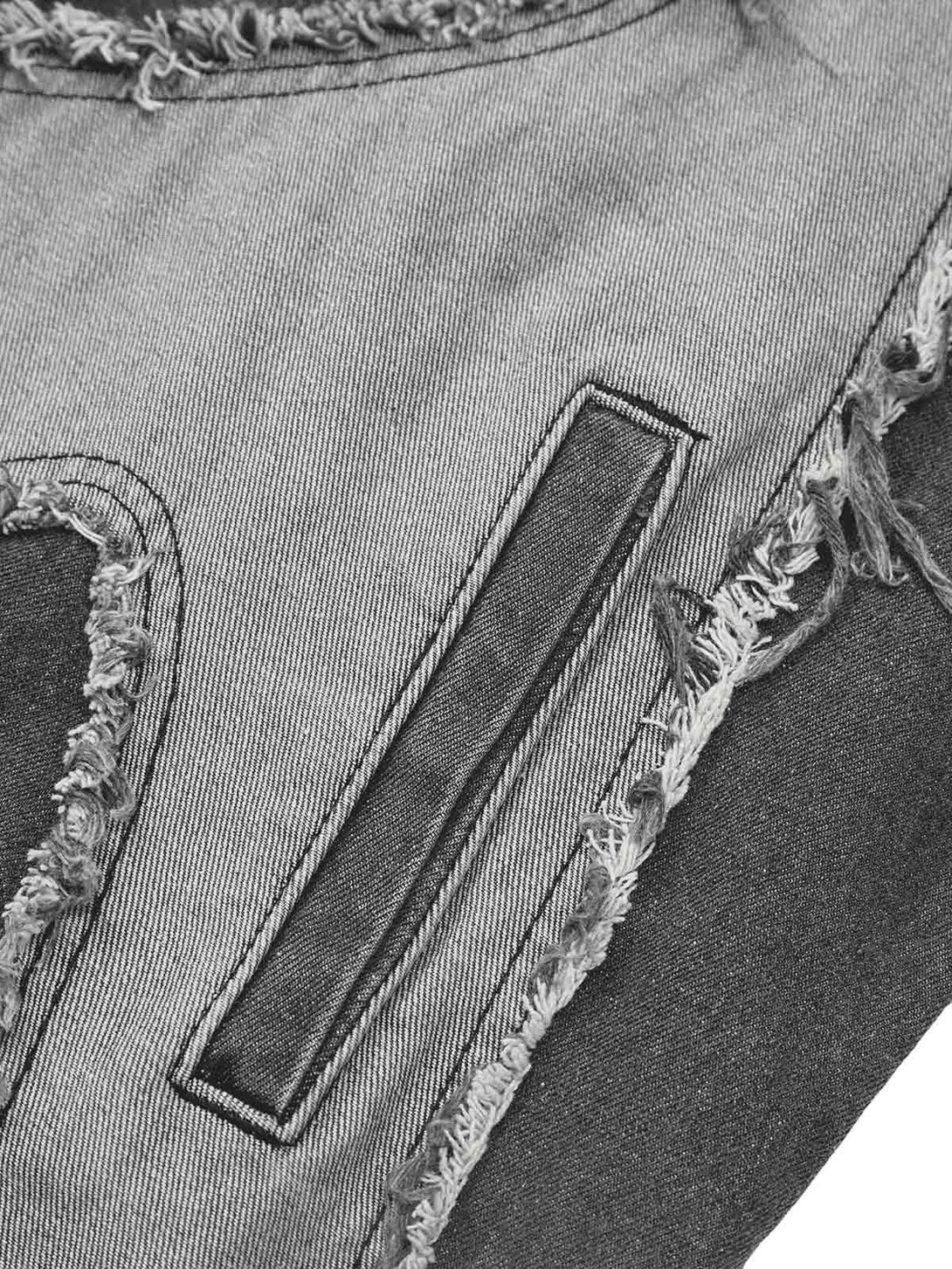 Detailed fabric and stitching on TALISHKO's denim vest, highlighting frayed edges.