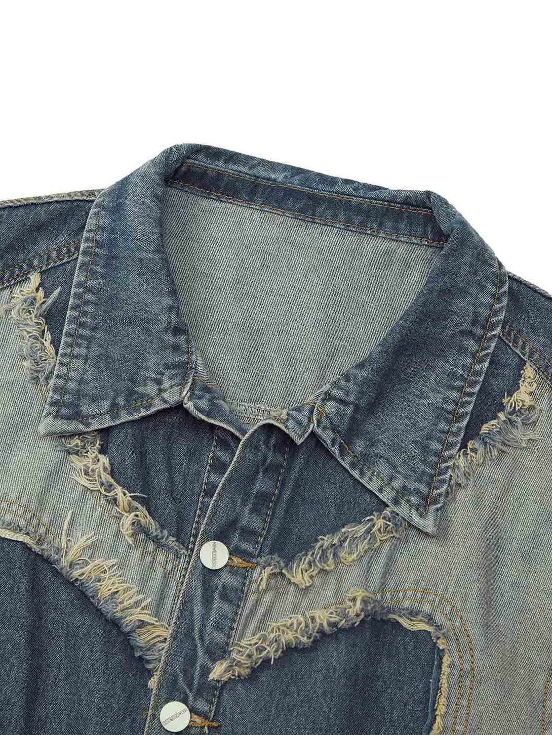 A close-up of TALISHKO's denim vest, featuring heart stitching and frayed edges.