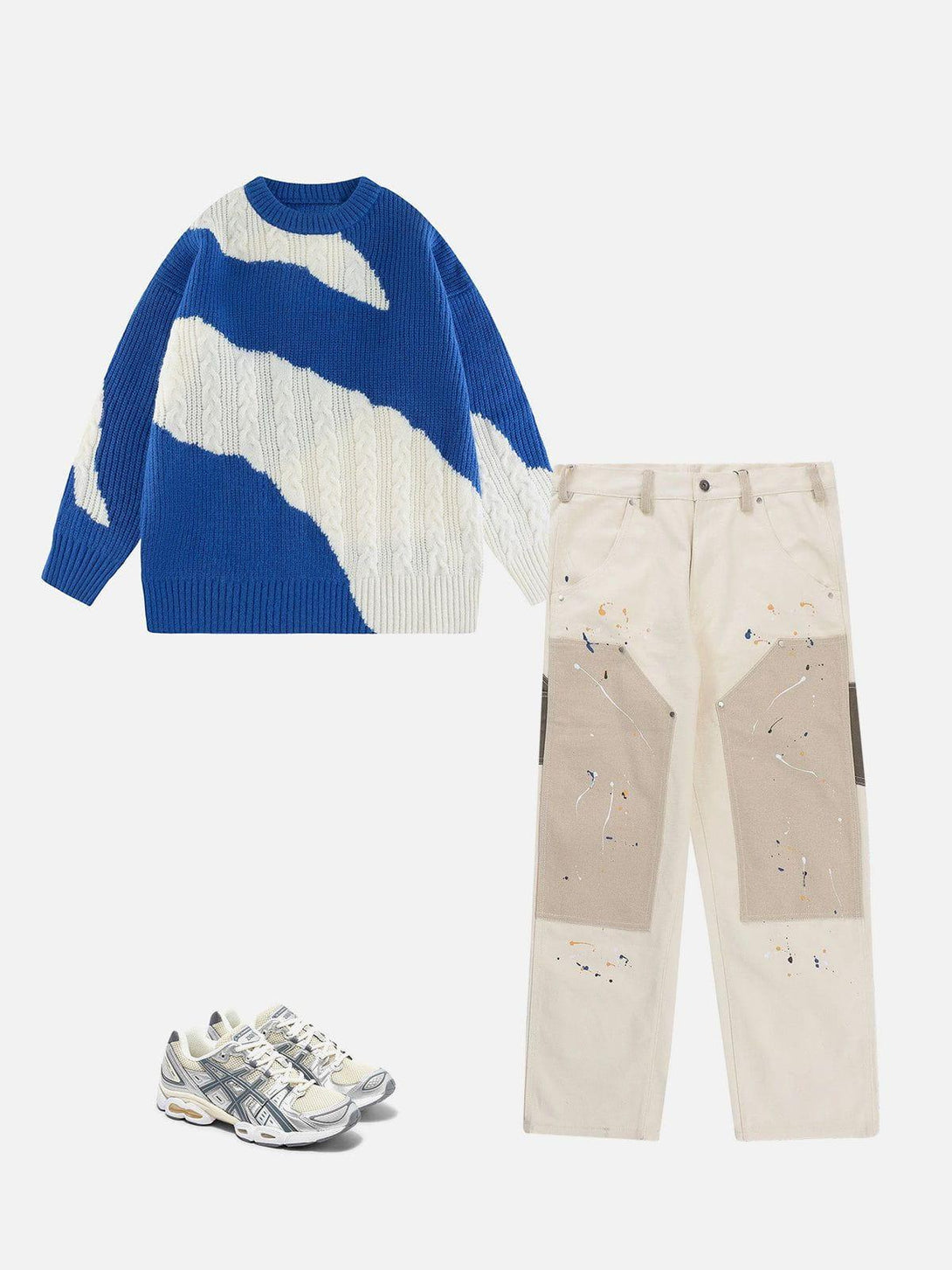 A stylish ensemble featuring a TALISHKO blue and white knit sweater with abstract design, paired with beige splatter pants and sneakers.