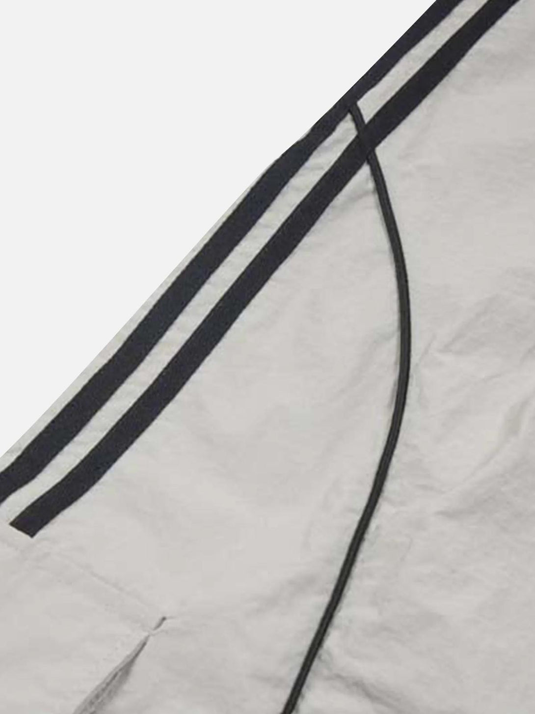 A tight crop highlighting TALISHKO's contrast striped detail on sweatpants for style inspiration.