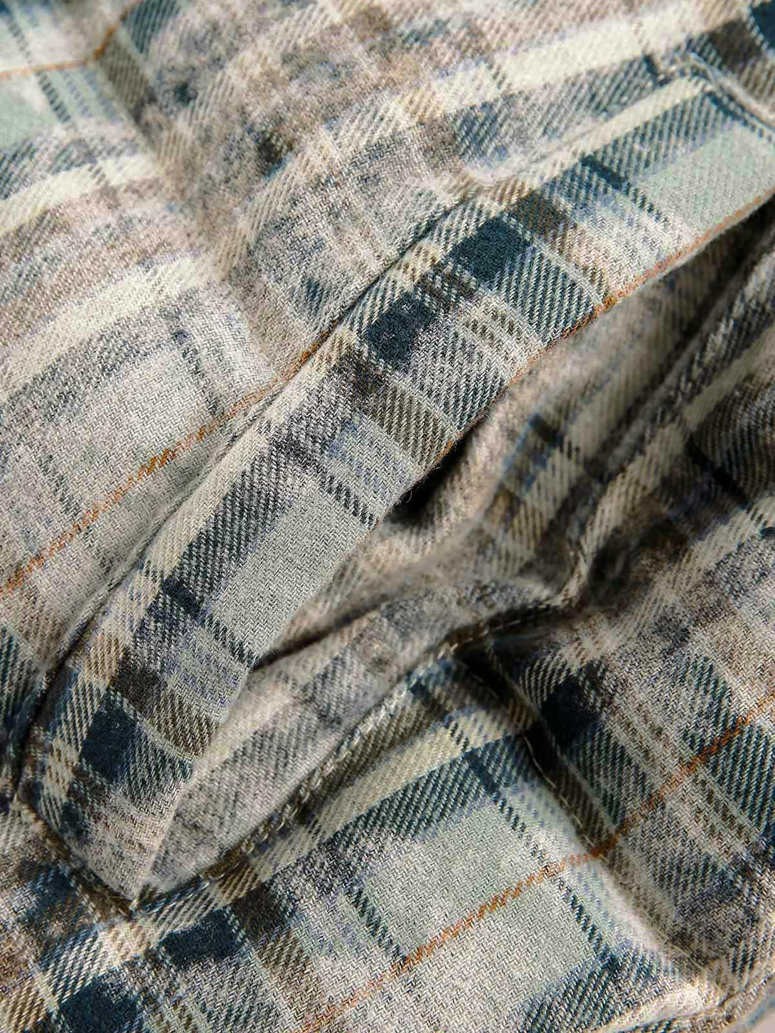 Texture and pattern showcased on a TALISHKO reversible jacket, emphasizing its plaid design.