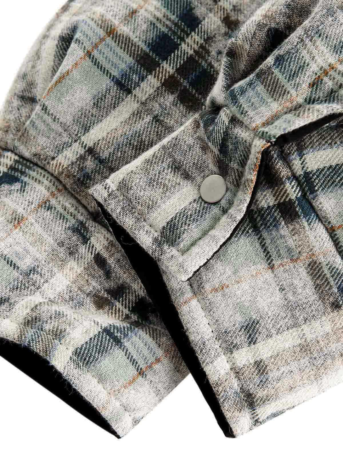 Detailed fabric and stitching on the TALISHKO reversible jacket, highlighting plaid texture.