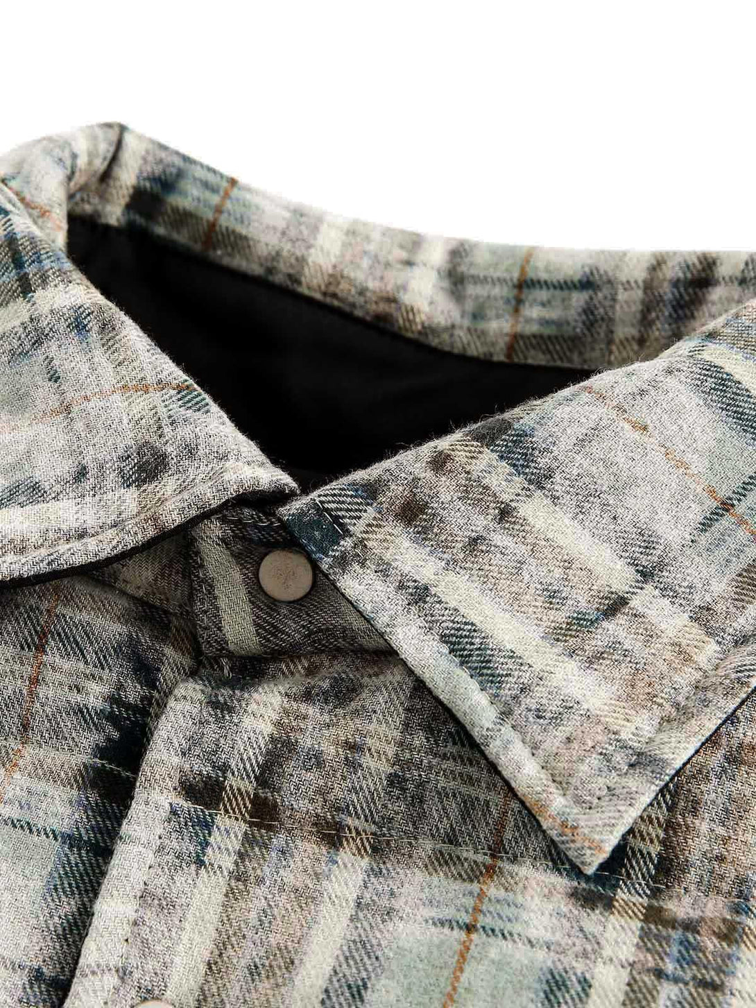 Intricate look at the TALISHKO reversible jacket's collar, featuring plaid design and texture.