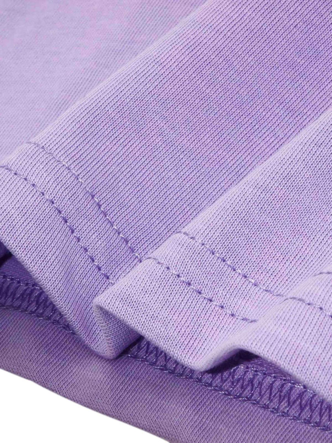 Detailed fabric and stitching on a purple T-shirt by TALISHKO, highlighting quality craftsmanship.