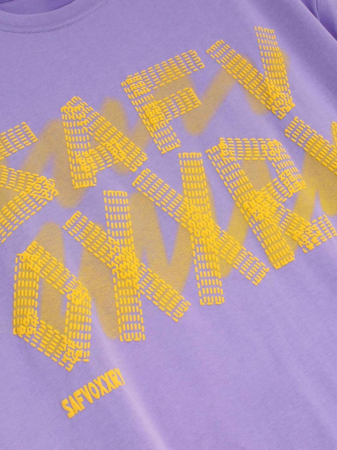 Purple T-shirt by TALISHKO, front view highlighting vibrant yellow alphabet pattern.