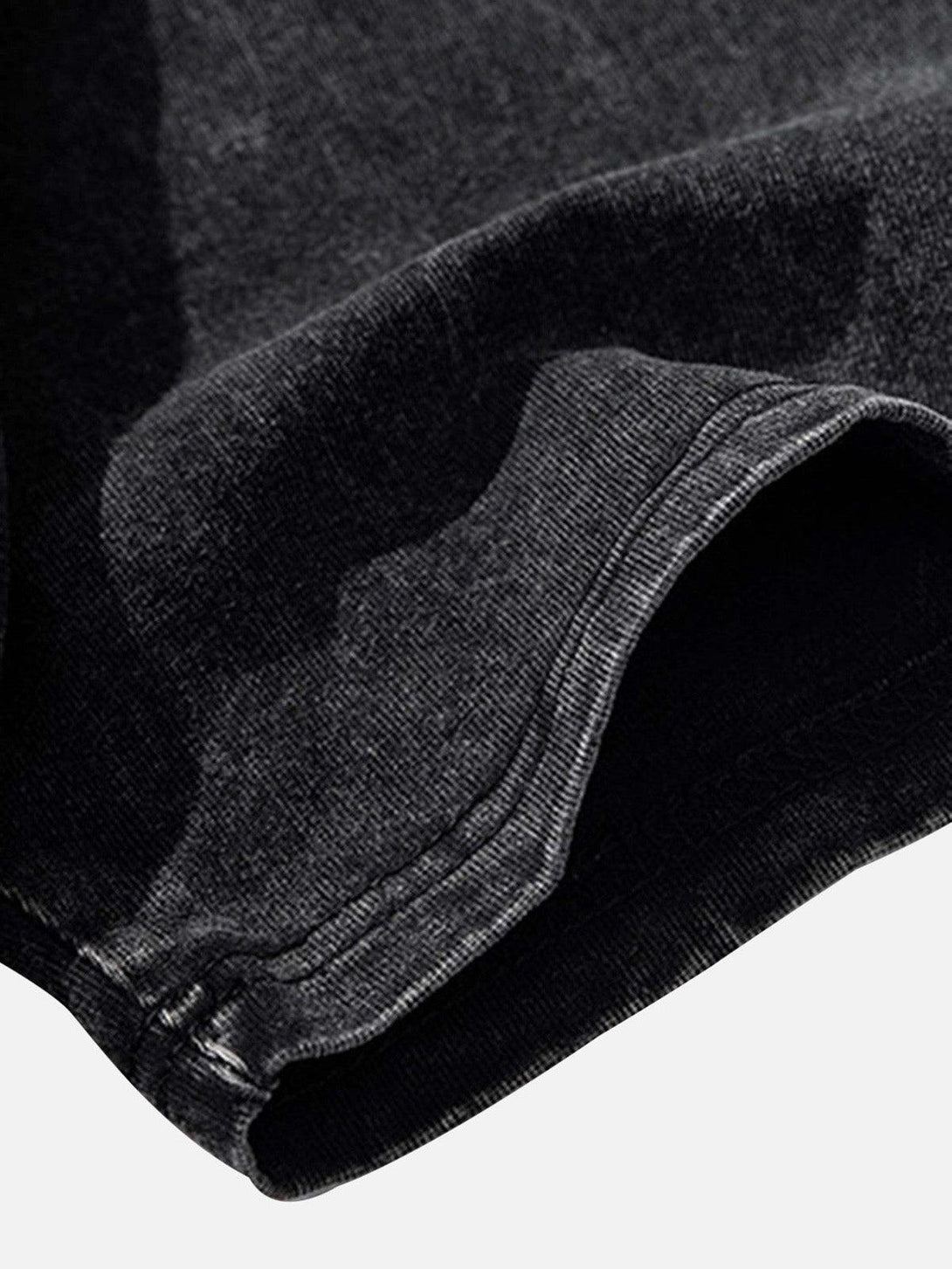 Close-up of black fabric and stitching detail on a TALISHKO T-shirt, showcasing craftsmanship.