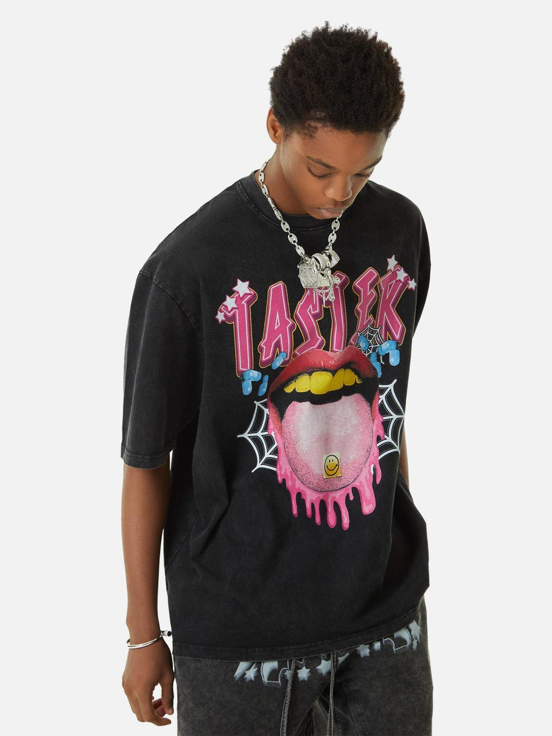 Model styled in a TALISHKO T-shirt, featuring a bold tongue graphic and vibrant colors.