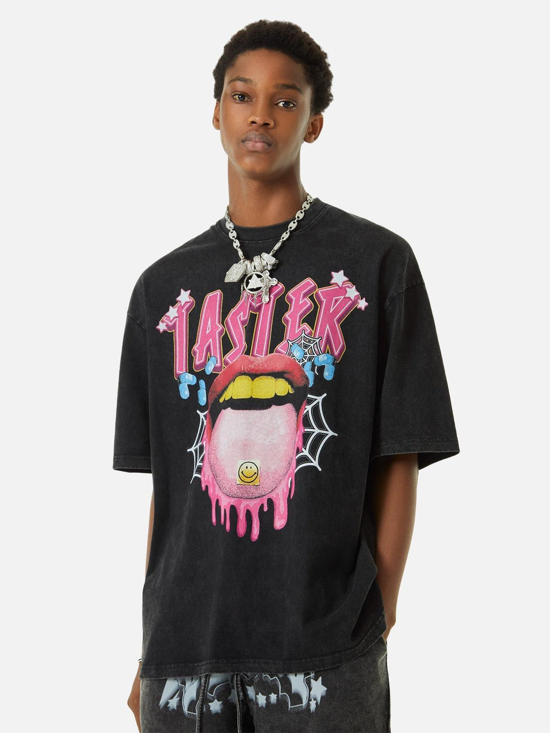 Model wearing a black T-shirt by TALISHKO with a bold, colorful graphic design.