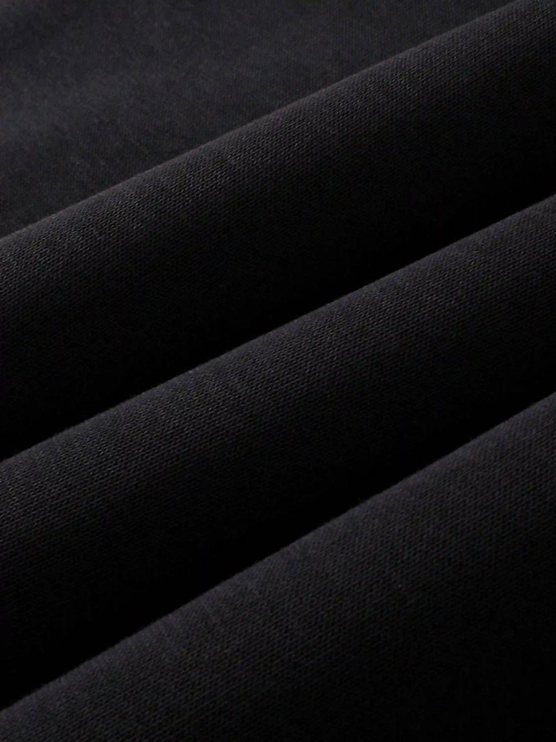 Texture and pattern showcased in a black TALISHKO hoodie, highlighting quality craftsmanship.