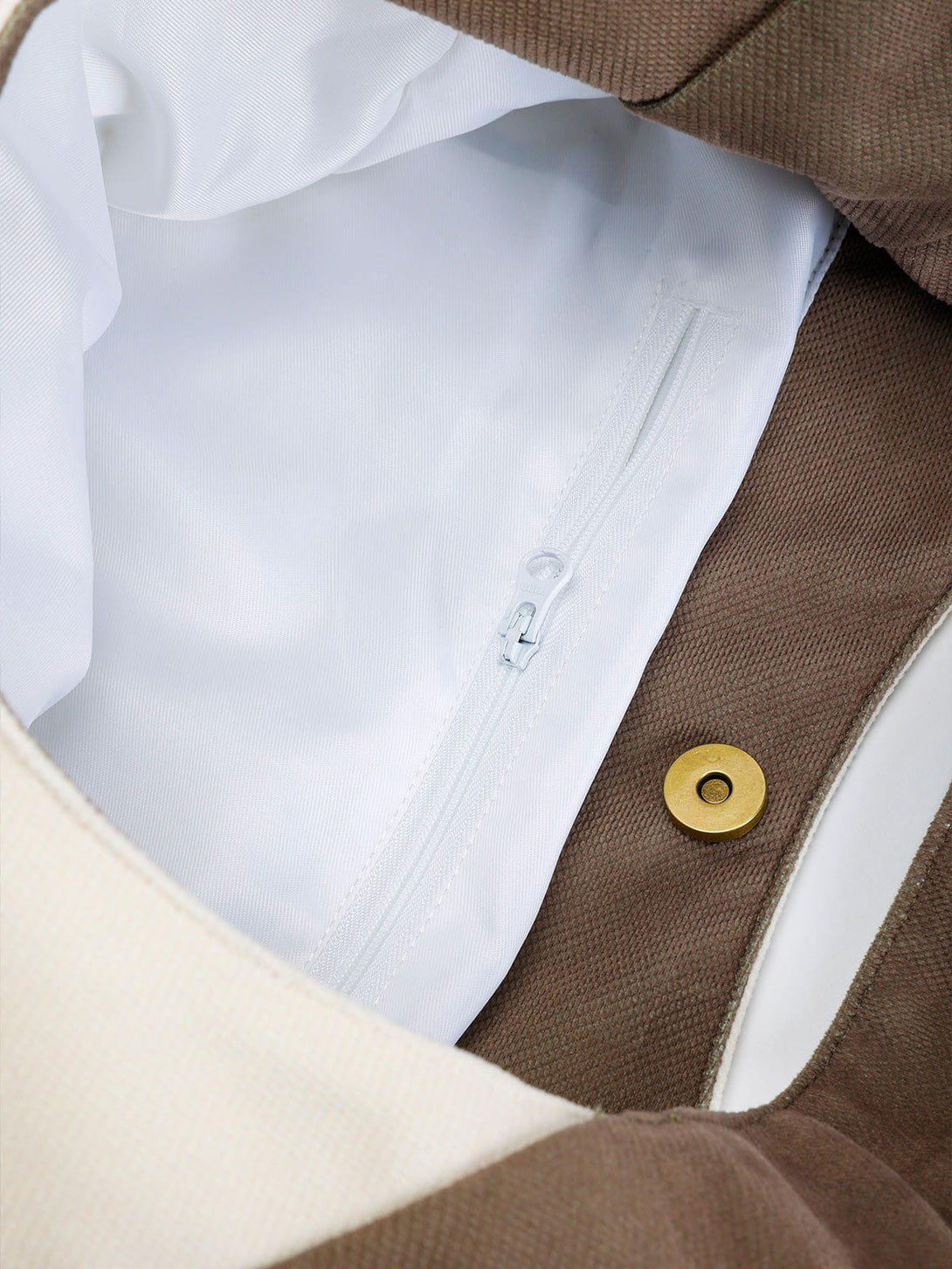 Intricate look inside the TALISHKO canvas bag, featuring a white zippered pocket detail.