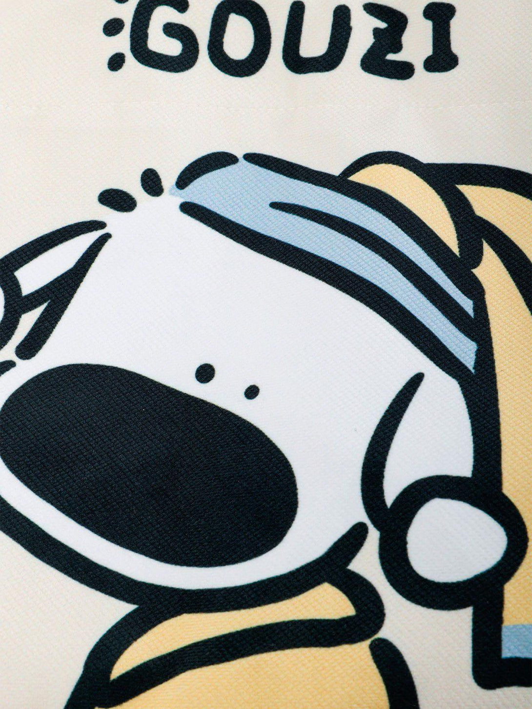 Zoomed-in view of the TALISHKO canvas bag's whimsical puppy pattern, showcasing its playful design.