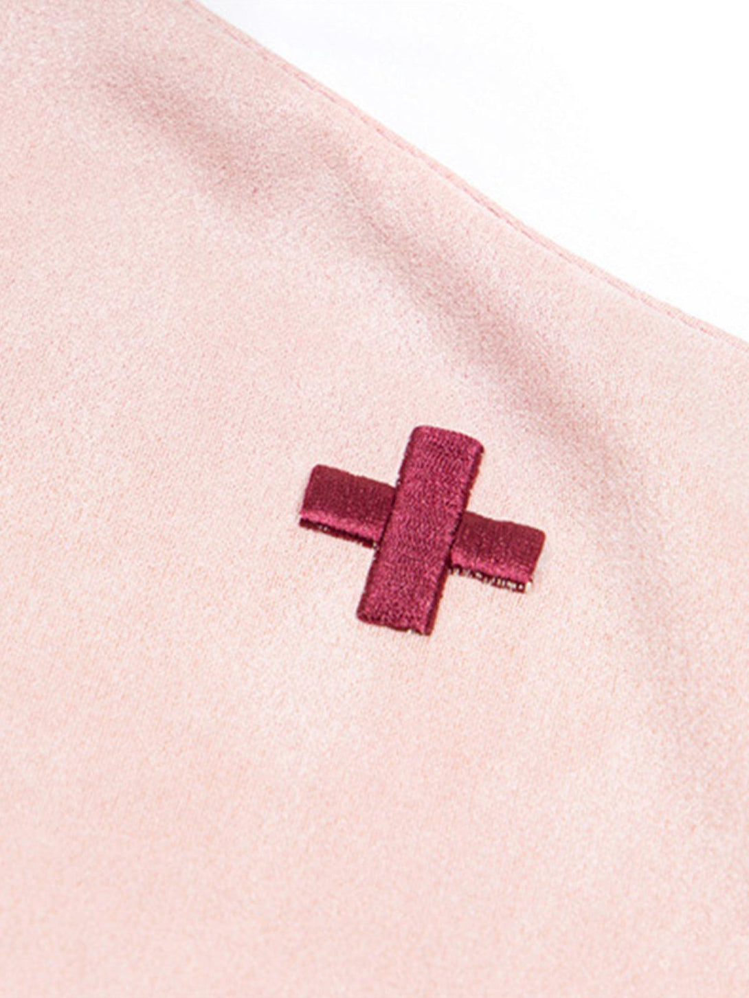 A detailed view of TALISHKO T-shirt's cross design, highlighting its unique texture and style.
