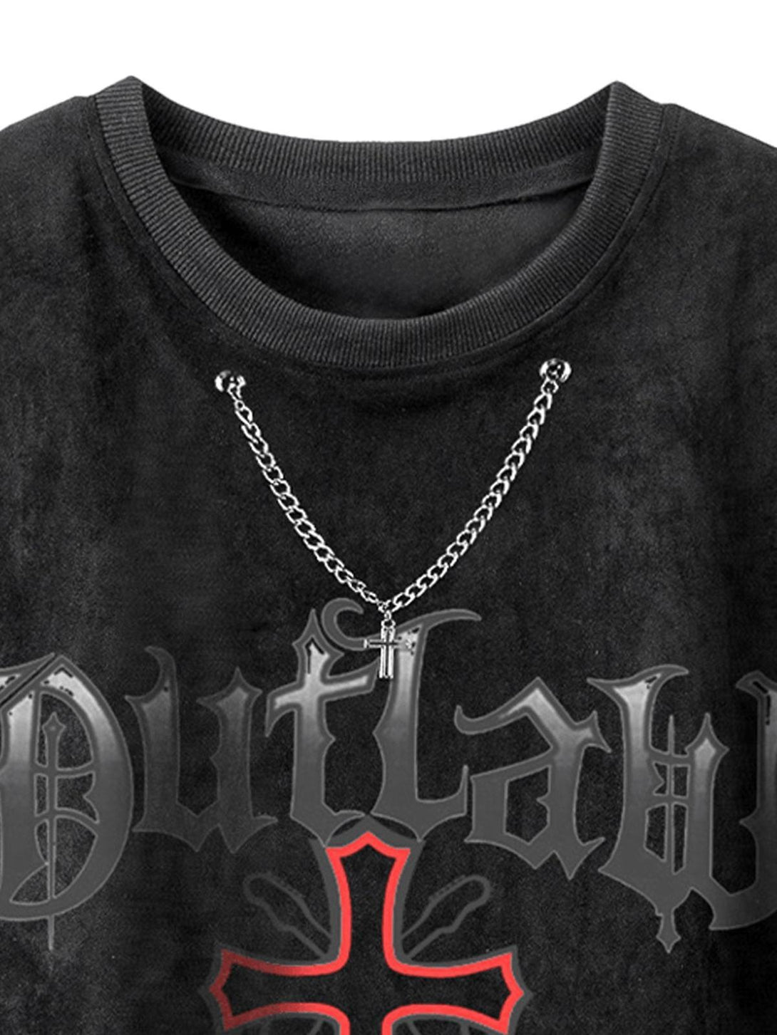 Close-up of TALISHKO's black suede vest, featuring a bold graphic and chain detail.